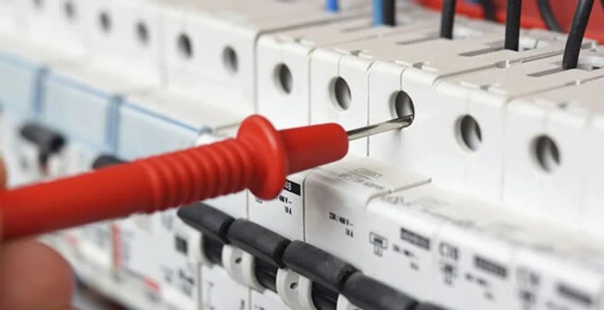 Electrical contractor testing circuit breakers during electrical repair in Leawood, KS