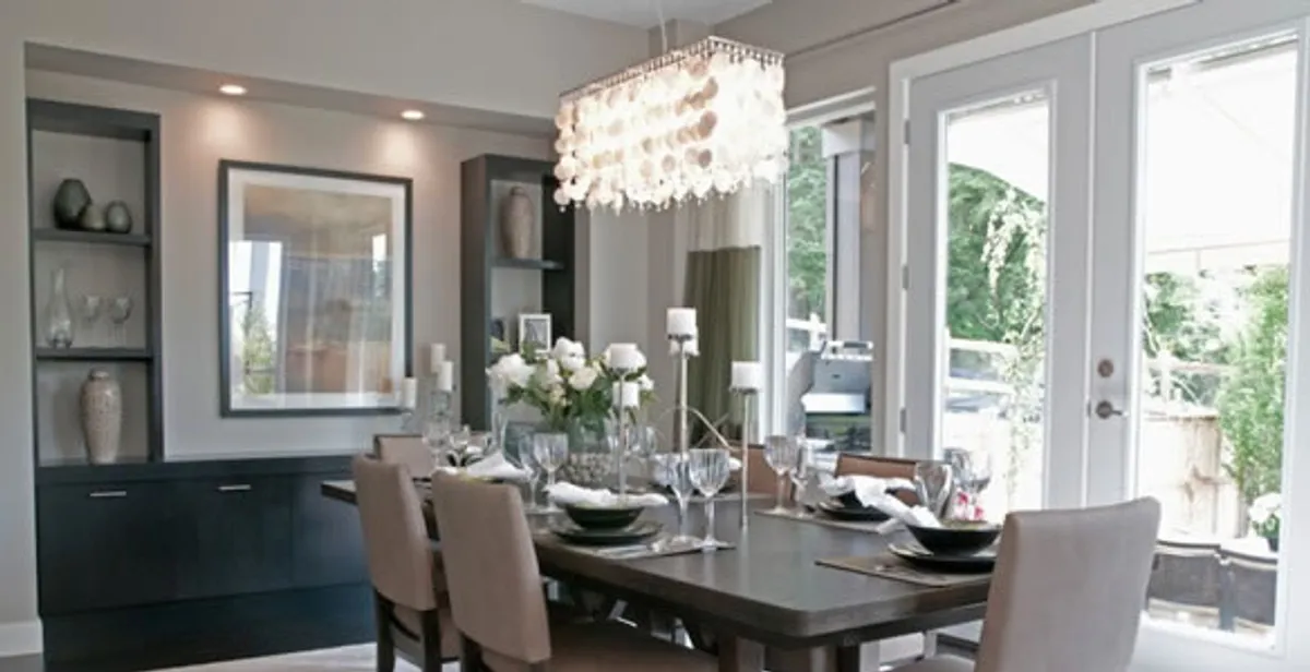 Elegant dining room chandelier installation above table in Olathe, KS