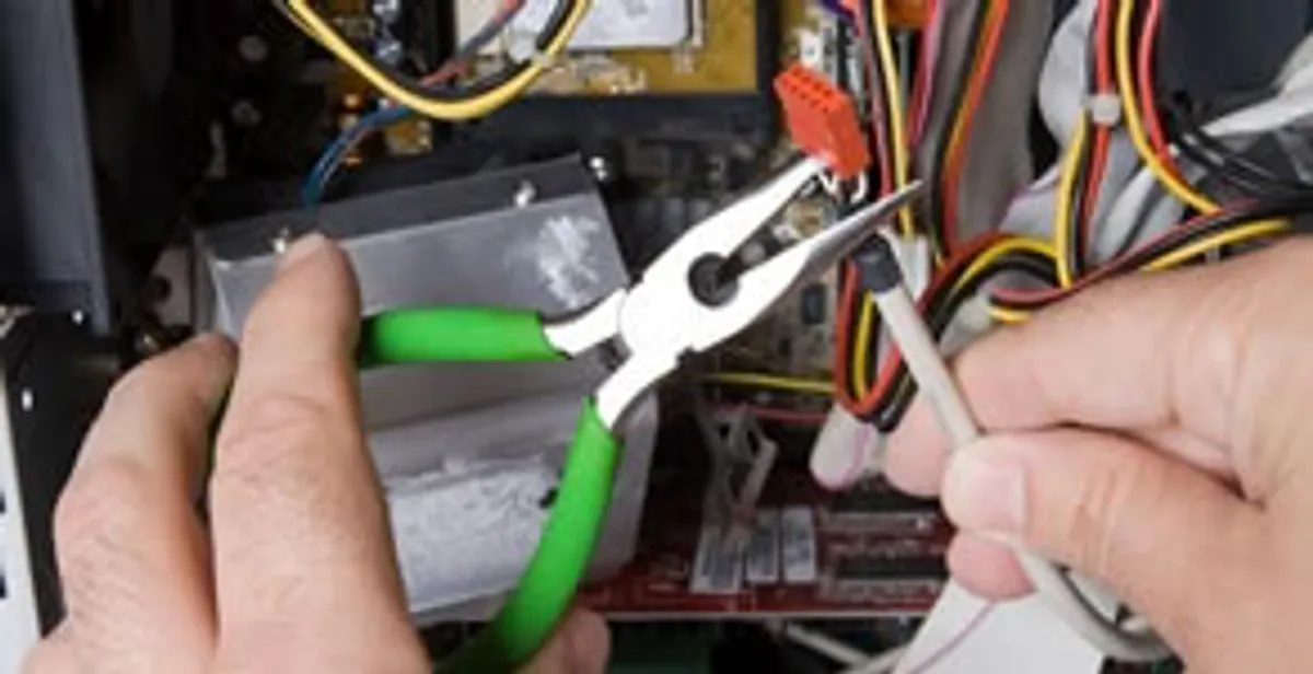 Licensed electrical contractor performing electrical repair with tools in Leawood, KS